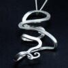 Gender neutral silver & filigree pendant reclining