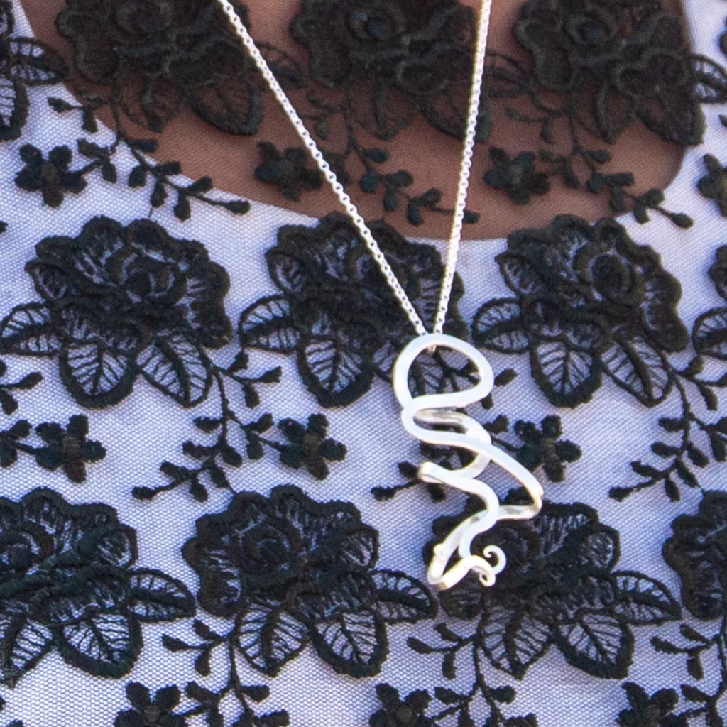 Gender neutral silver & filigree pendant worn