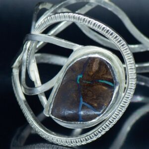 Remodelled heirloom silver bracelet with veined opal closeup