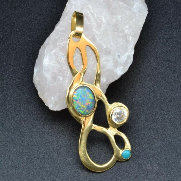 Bespoke gold and opal pendant displayed