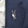 Modern silver dove lapel pin on a blazer