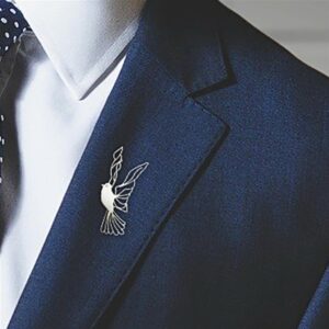 Modern silver dove lapel pin on a model