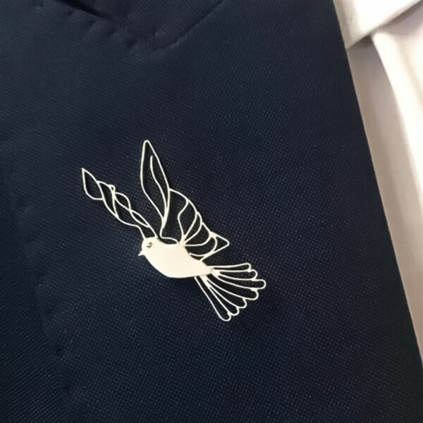 Modern silver dove lapel pin on suit