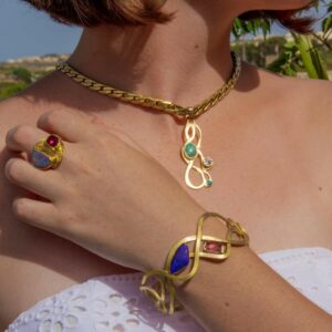 Designer gold bracelet with opal and tourmaline worn