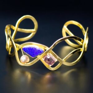Designer gold bracelet with opal and tourmaline front